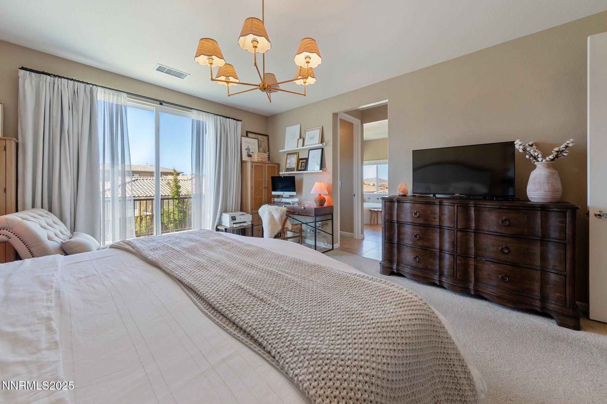 9845 Copenhagen Way Reno, NV 89521 - Photo 22 of 57 a bedroom with a bed and a television