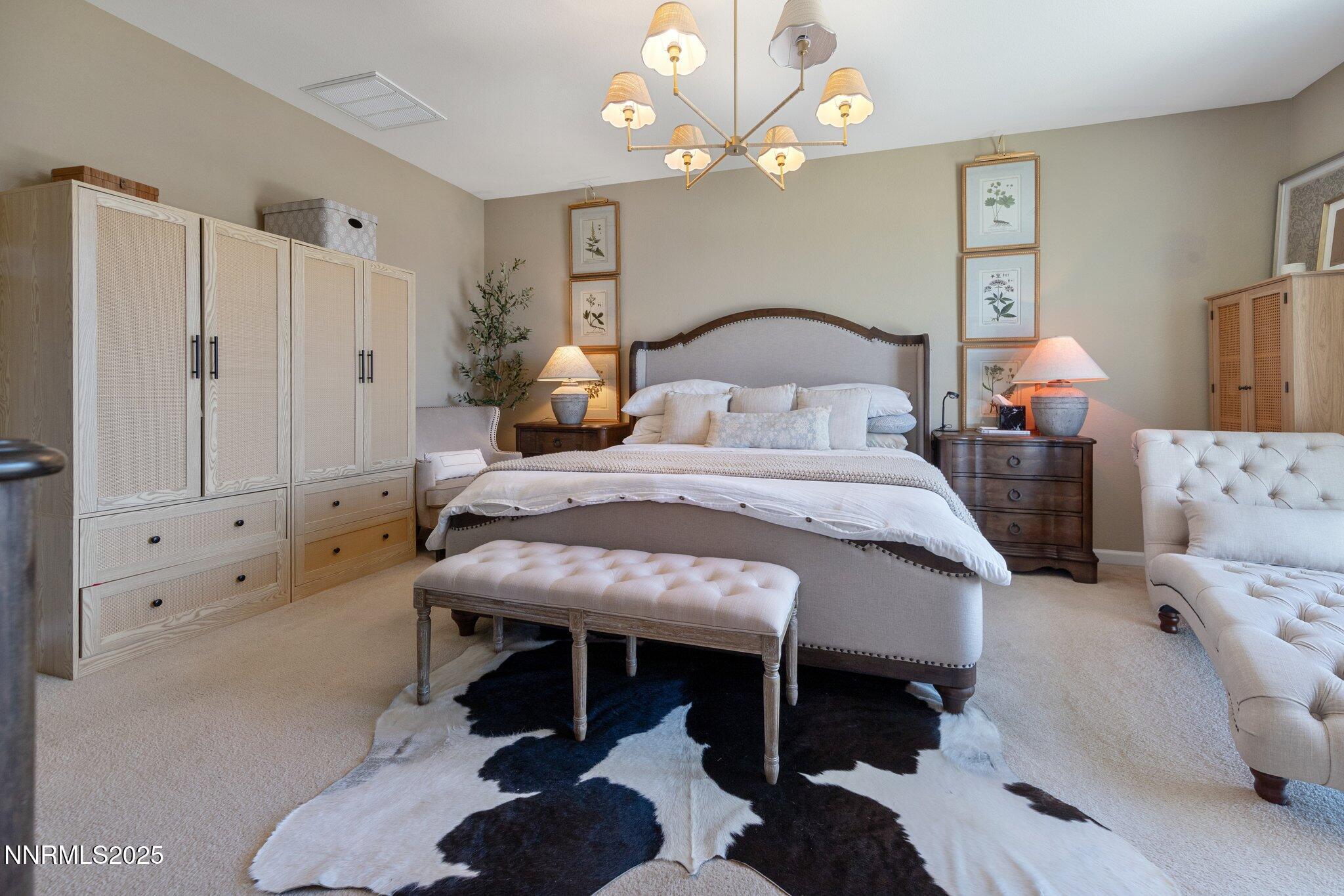 9845 Copenhagen Way Reno, NV 89521 - Photo 29 of 57 a bedroom with a bed and a chandelier