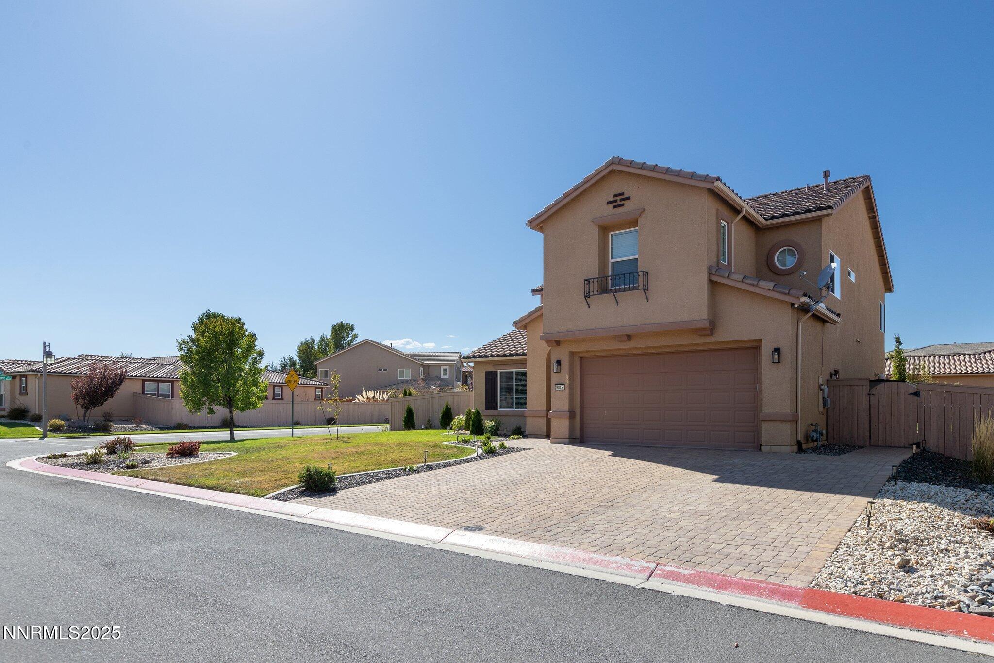 9845 Copenhagen Way Reno, NV 89521 - Photo 35 of 57 a front view of a house with a yard and garage