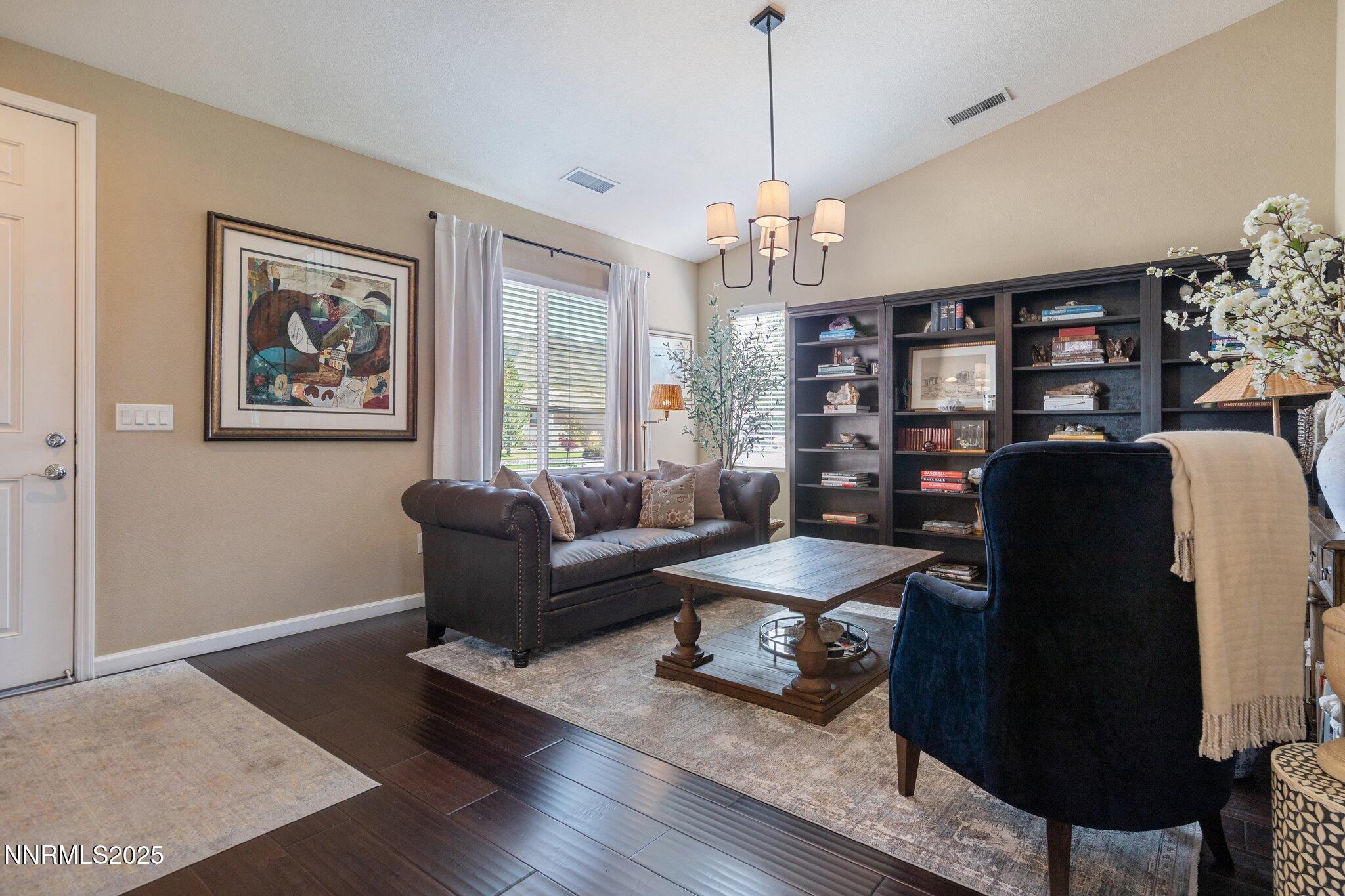 9845 Copenhagen Way Reno, NV 89521 - Photo 5 of 57 a living room with furniture a window and a chandelier
