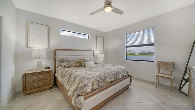 a bedroom with a bed and a chandelier