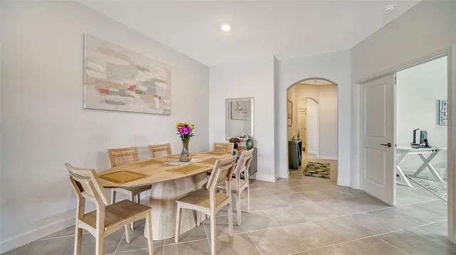 a view of a dining room with furniture and a chandelier