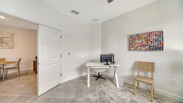 a view of a workspace with furniture and a workspace