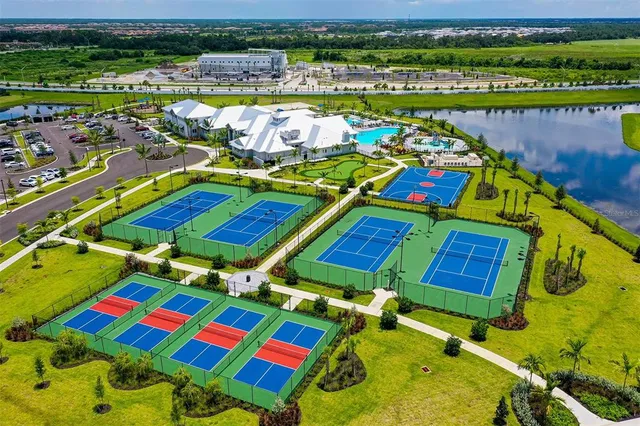 an aerial view of a pool and chairs