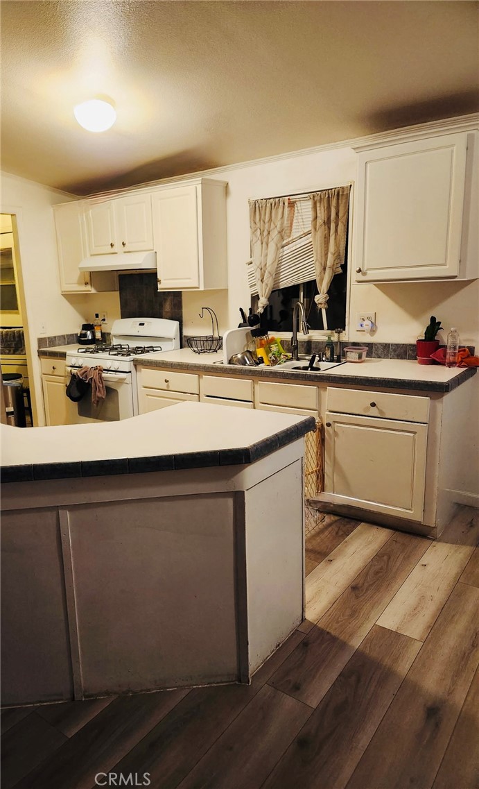 13139 Zane Way Whitewater, CA 92282 - Photo 6 of 11 a kitchen with a sink stove and cabinets