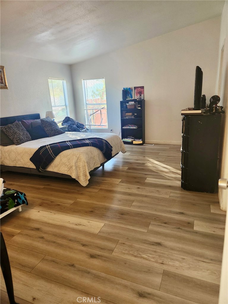 13139 Zane Way Whitewater, CA 92282 - Photo 10 of 11 a bedroom with a bed and wooden floor