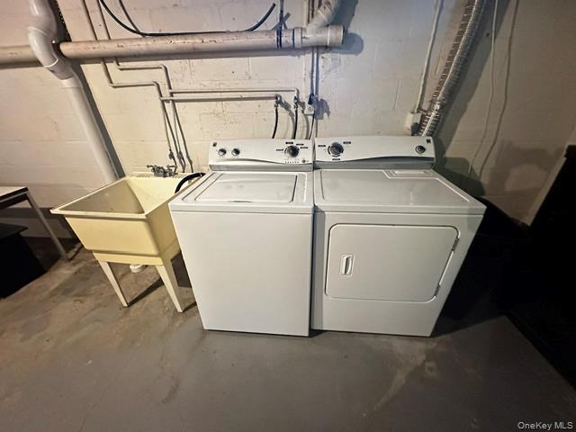 97 Cold Spring Road Stanfordville, NY 12581 - Photo 14 of 16 Laundry area featuring a side-by-side washer and dryer set, a utility sink, and concrete flooring