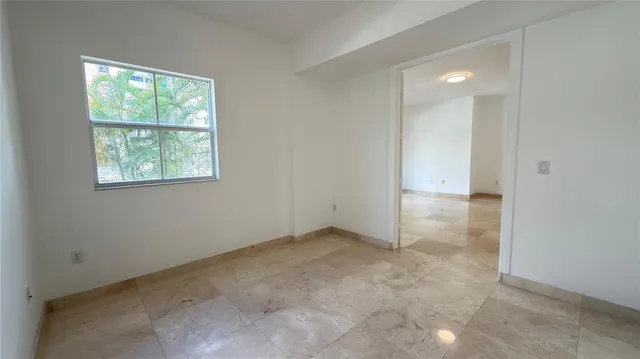 a kitchen with granite countertop wooden cabinets and a sink