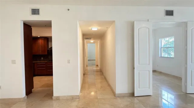 a kitchen with stainless steel appliances granite countertop a refrigerator and cabinets