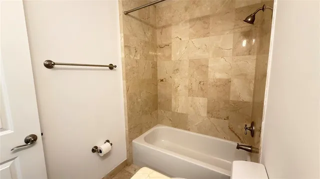 a view of a room with a large window and front door