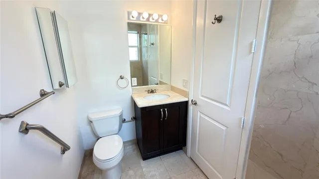 a front view of a building with street view and trees