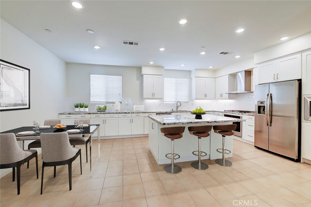 230 Harringay Irvine, CA 92618 - Photo 3 of 21 a kitchen with a dining table chairs appliances and cabinets