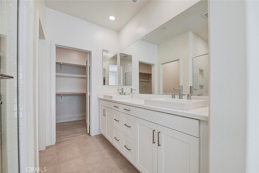 230 Harringay Irvine, CA 92618 - Photo 5 of 21 a bathroom with a double vanity sink and mirror