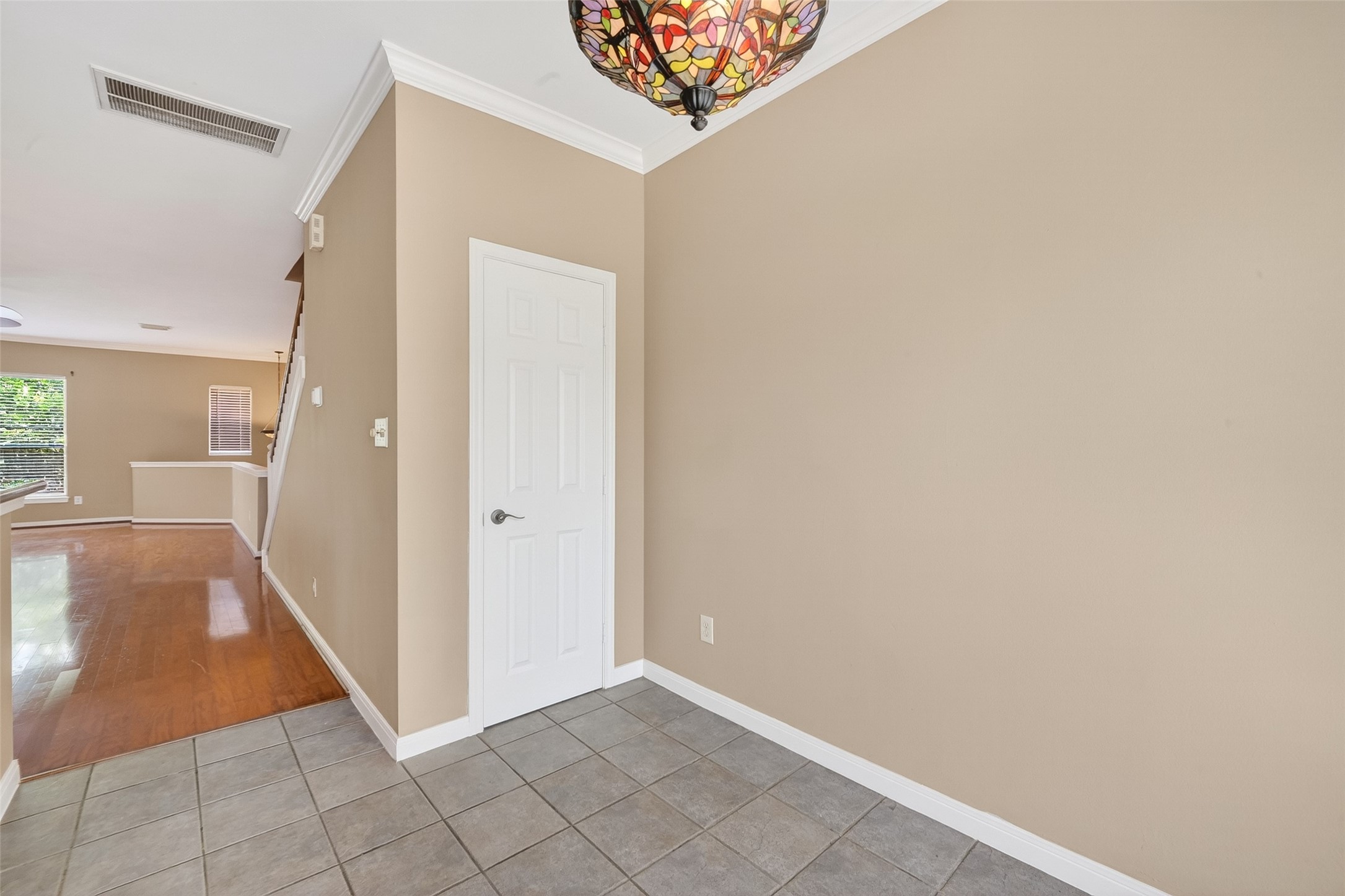 2804 Chenevert Street Houston, TX 77004 - Photo 12 of 37 a view of a hallway to an empty room with wooden floor and a large window