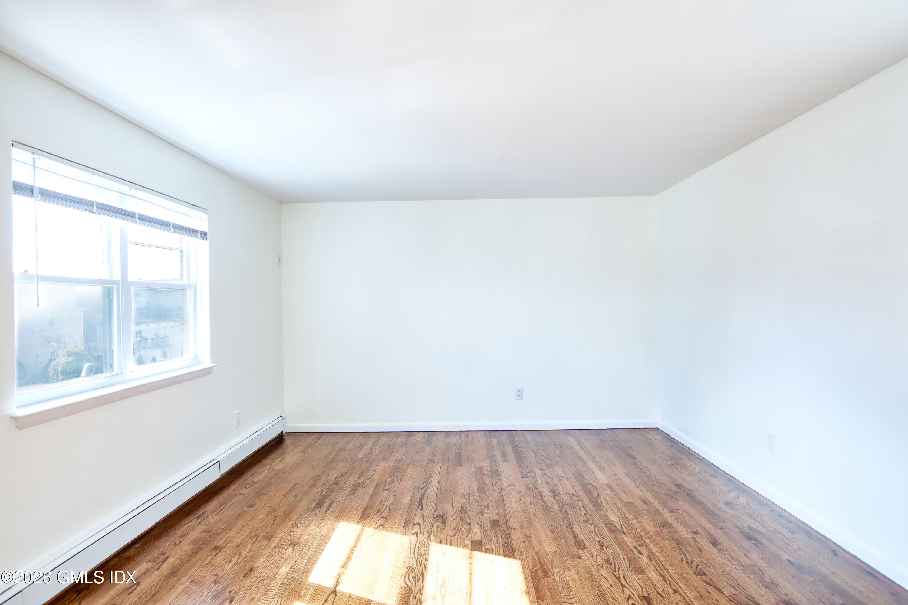 25 Alexander Street, Unit B Greenwich, CT 06830 - Photo 2 of 26 an empty room with a window