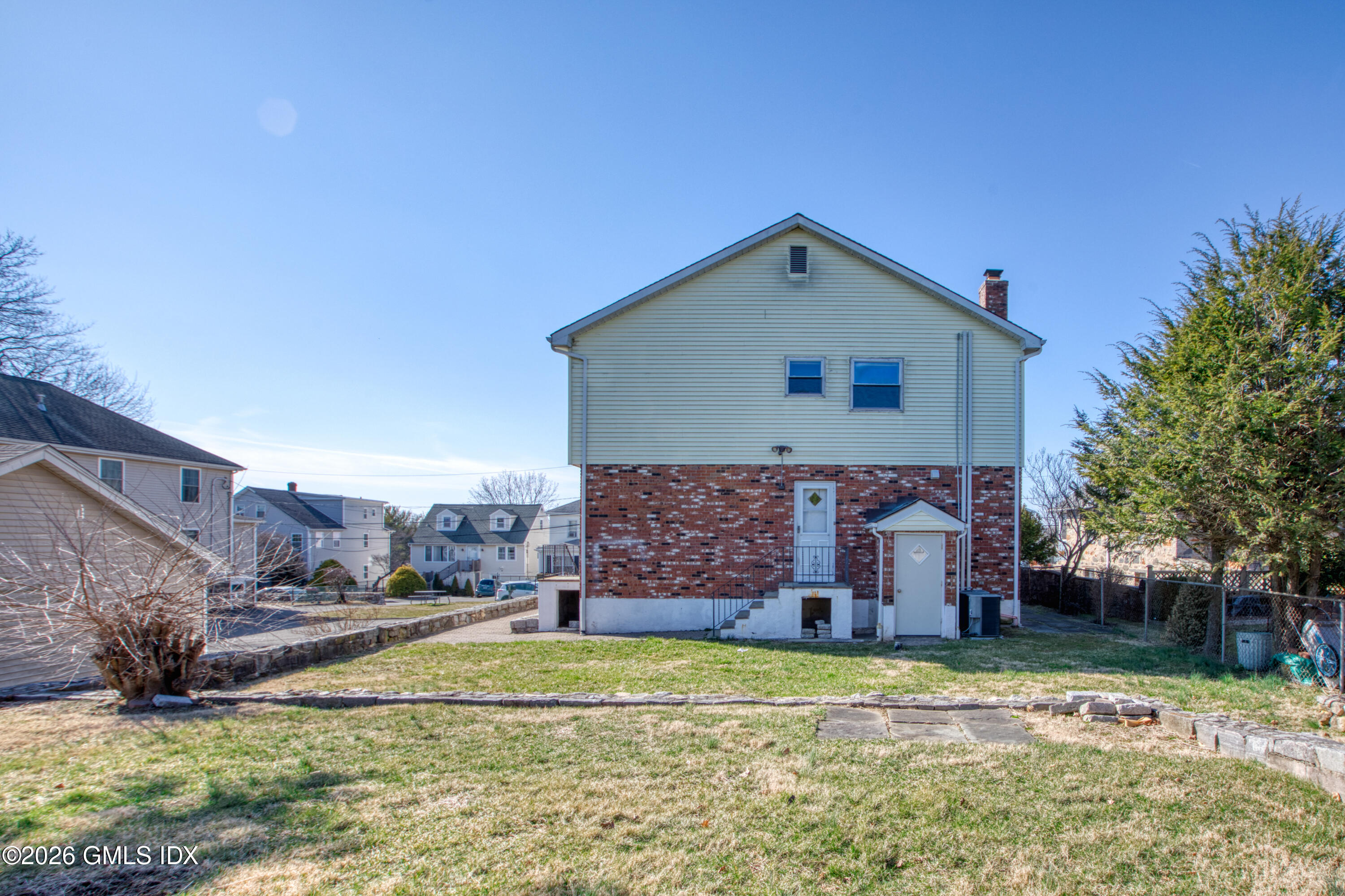 25 Alexander Street, Unit B Greenwich, CT 06830 - Photo 21 of 26 a view of a house with a yard