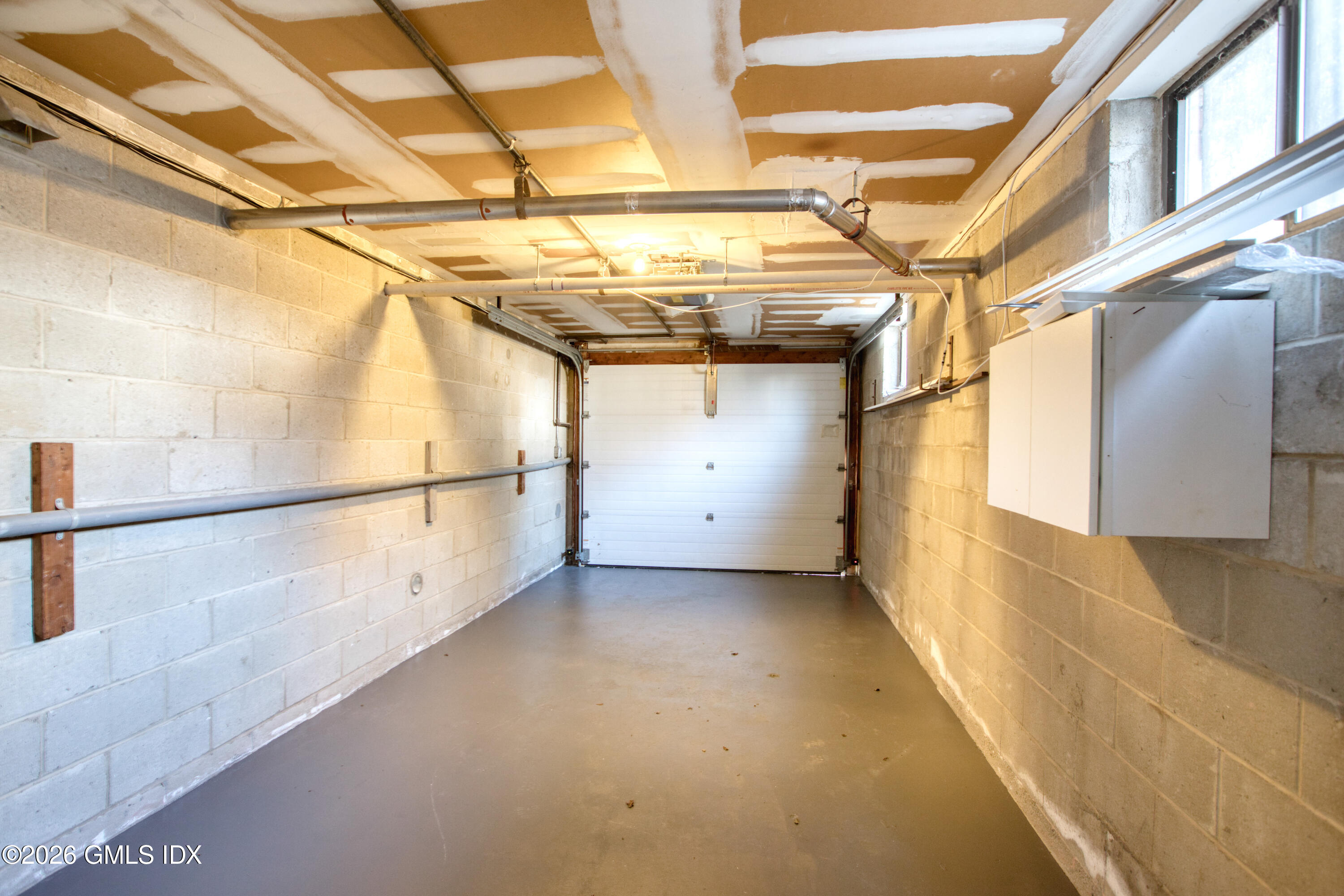 25 Alexander Street, Unit B Greenwich, CT 06830 - Photo 23 of 26 a view of a room with racks on the wall