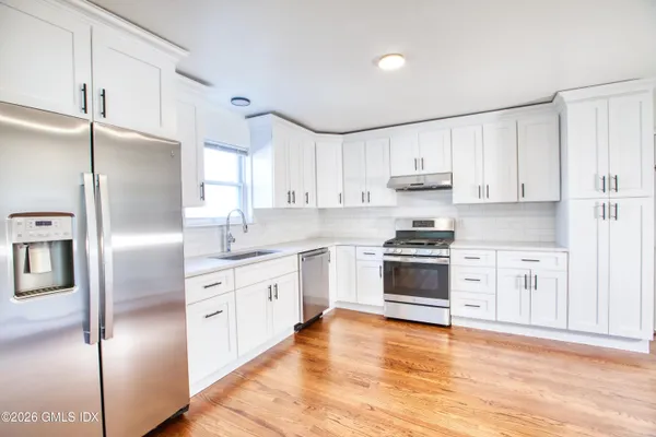 a kitchen with stainless steel appliances cabinets a sink and a counter space