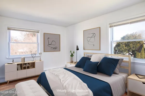 a living room with a bed furniture and a window