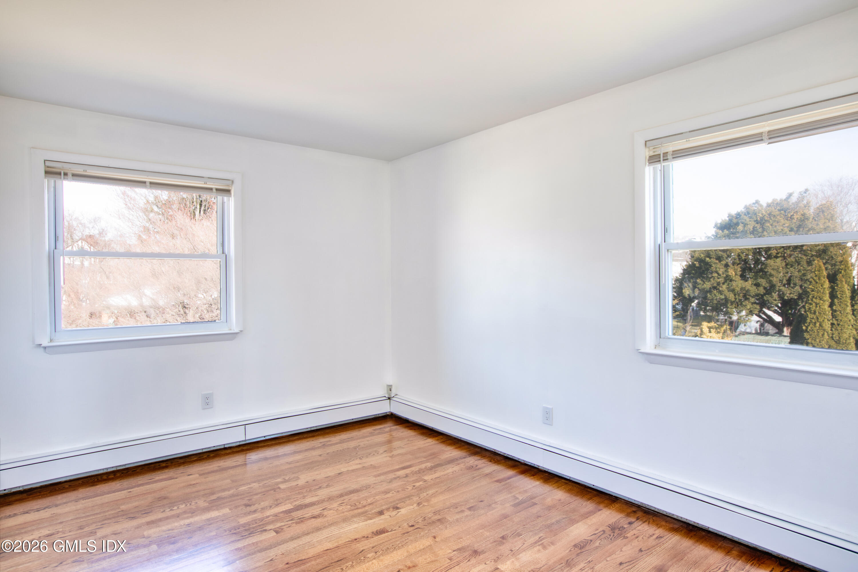 25 Alexander Street, Unit B Greenwich, CT 06830 - Photo 7 of 26 wooden floor in an empty room with a window