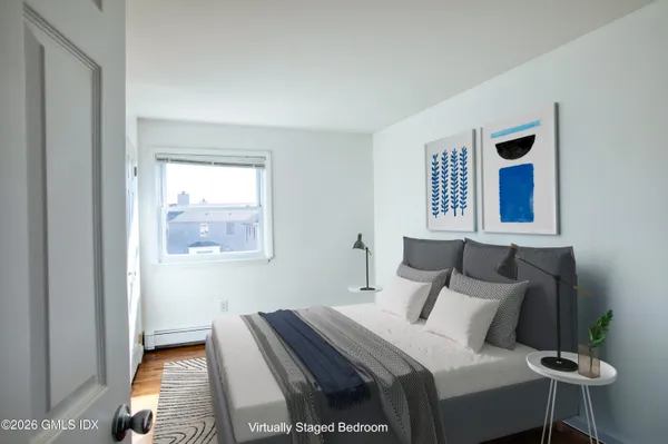 a bedroom with a bed and a window