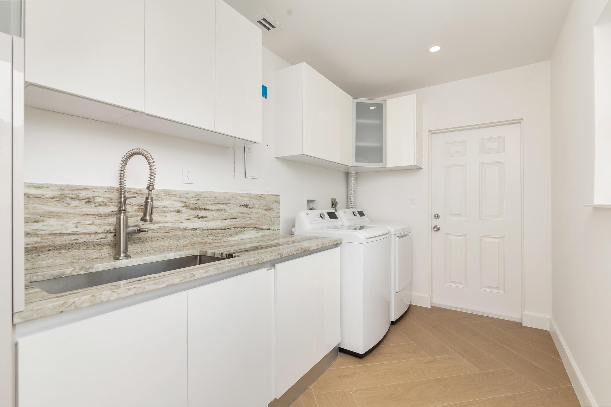 7320 Clarke Road West Palm Beach, FL 33406 - Photo 20 of 38 a kitchen with a sink and cabinets