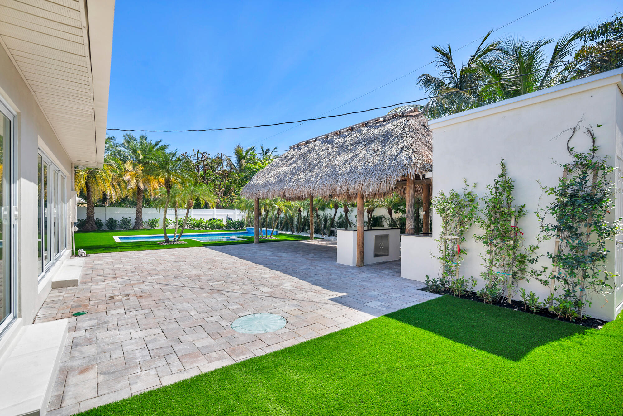 7320 Clarke Road West Palm Beach, FL 33406 - Photo 25 of 38 a view of a house with a yard and potted plants