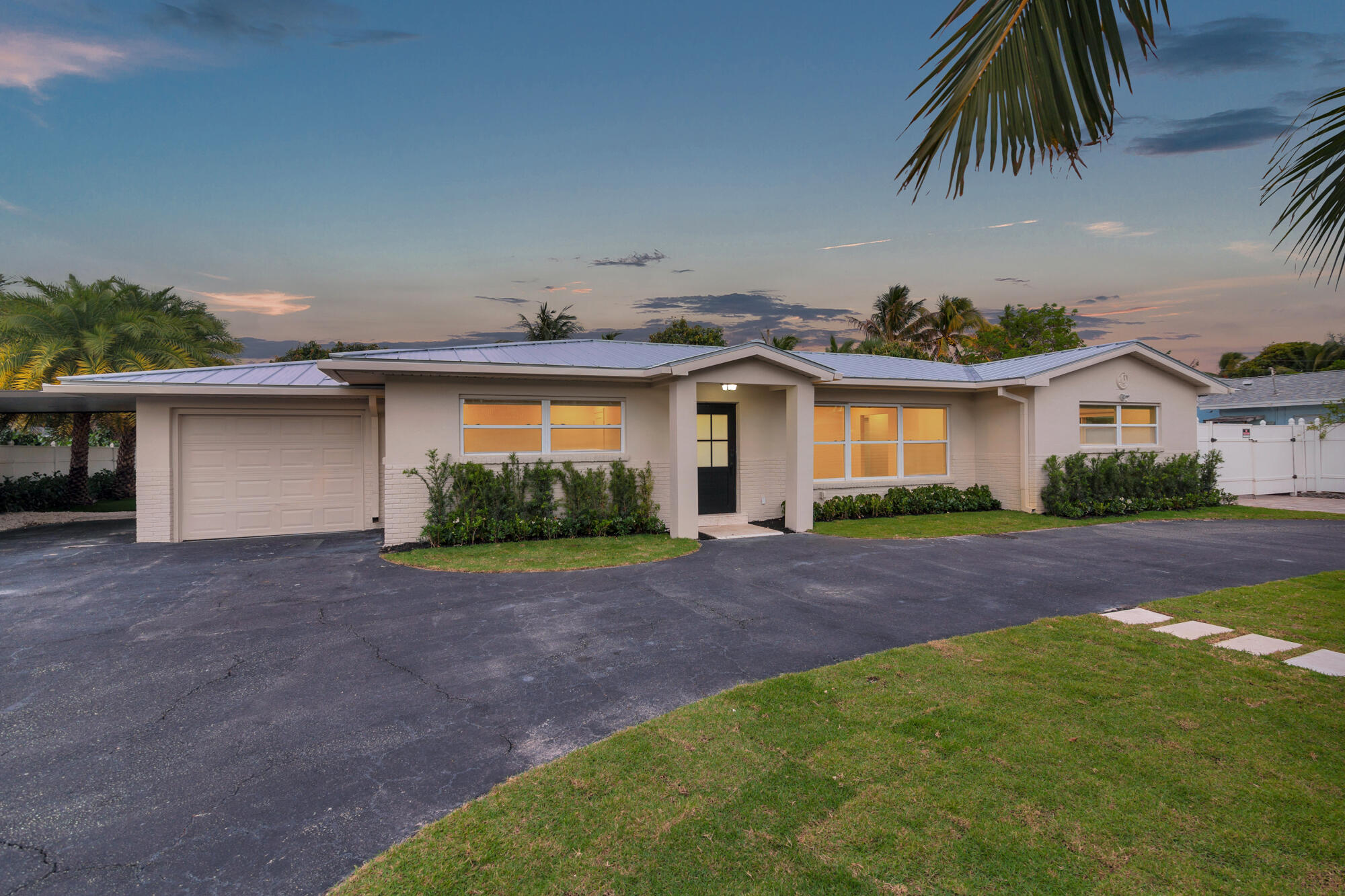 7320 Clarke Road West Palm Beach, FL 33406 - Photo 31 of 38 a front view of a house with a garden