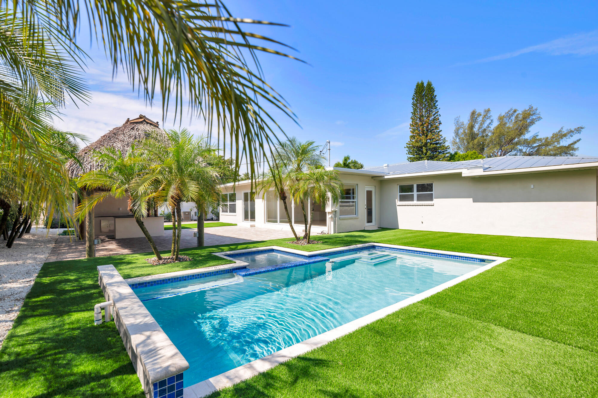 7320 Clarke Road West Palm Beach, FL 33406 - Photo 4 of 38 a view of swimming pool with lawn chairs and plants