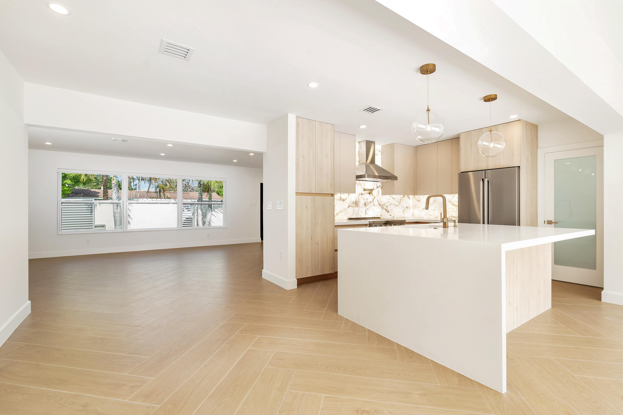7320 Clarke Road West Palm Beach, FL 33406 - Photo 7 of 38 a kitchen with kitchen island wooden cabinets and refrigerator