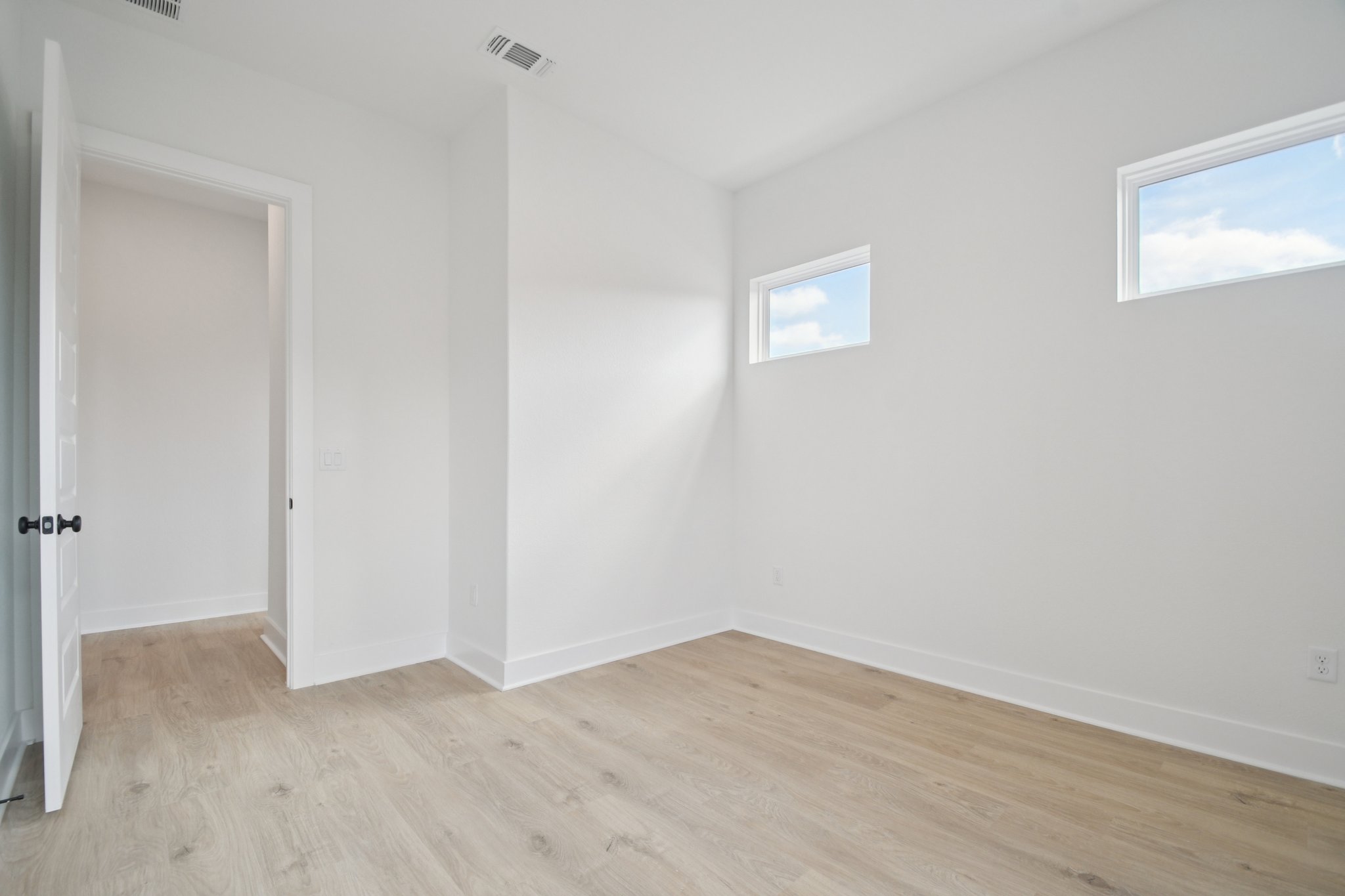 1660 Cardinal Lane Round Rock, TX 78681 - Photo 11 of 35 a view of an empty room with wooden floor and a window