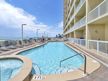 a view of a swimming pool with outdoor seating