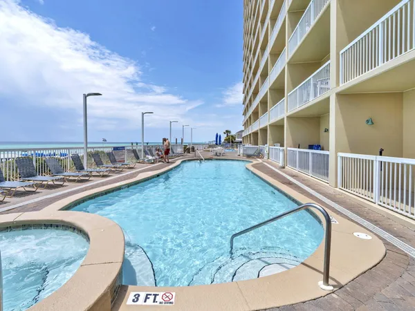 a view of a swimming pool with outdoor seating