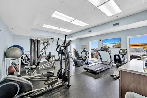 a room with gym equipment and view of living room