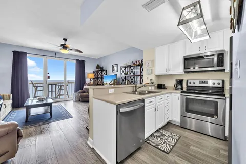 a kitchen with a sink a stove and cabinets
