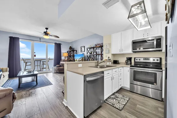 a kitchen with a sink a stove and cabinets