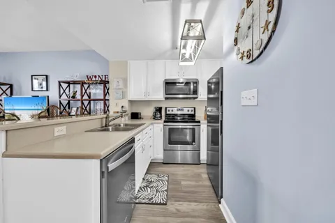 a kitchen with stainless steel appliances granite countertop a sink and a stove