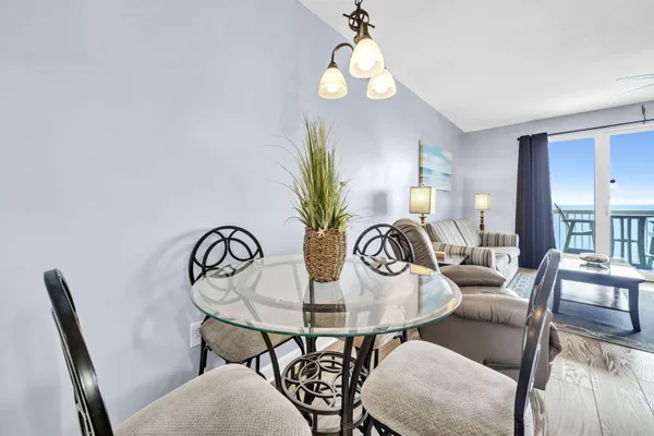 a view of a dining room with furniture and chandelier