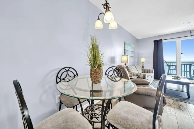 a view of a dining room with furniture and chandelier