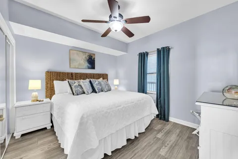 a bedroom with bed and wooden floor