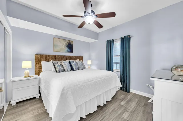 a bedroom with bed and wooden floor