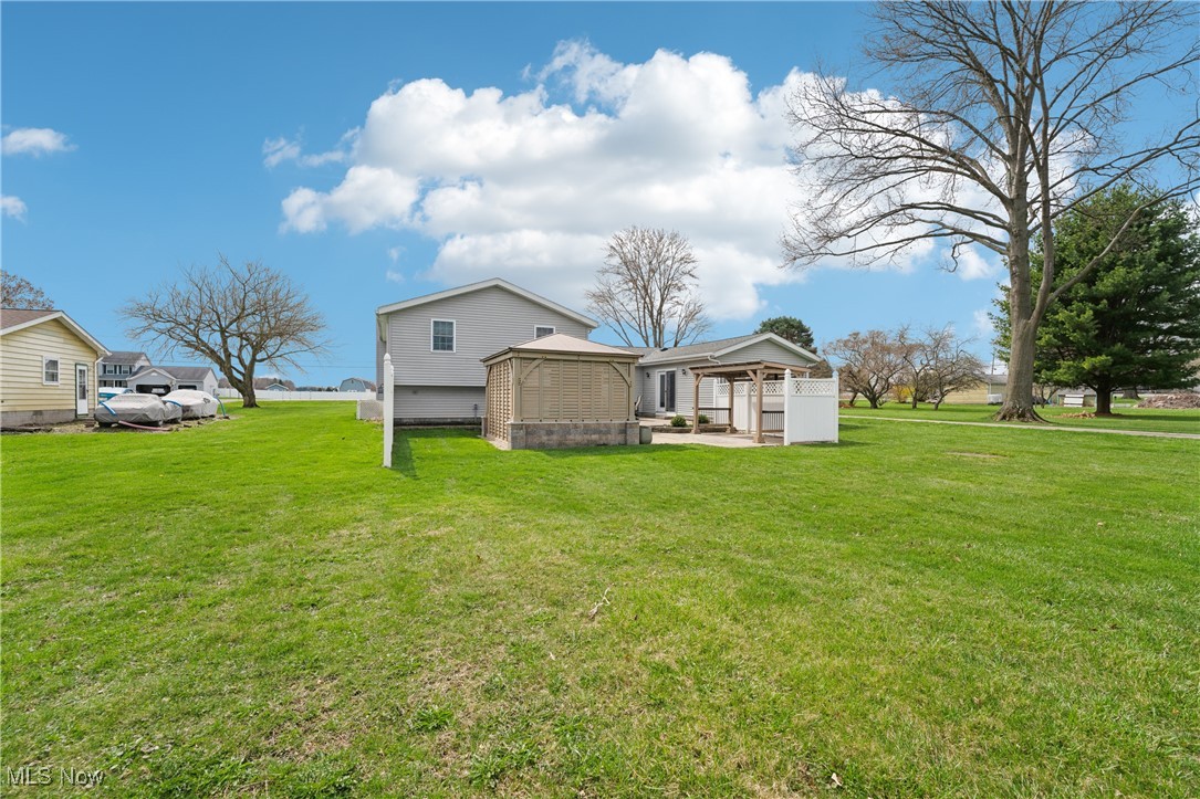 15415 Mason Road Vermilion, OH 44089 - Photo 42 of 50 Rear view of house featuring a lawn and a gazebo
