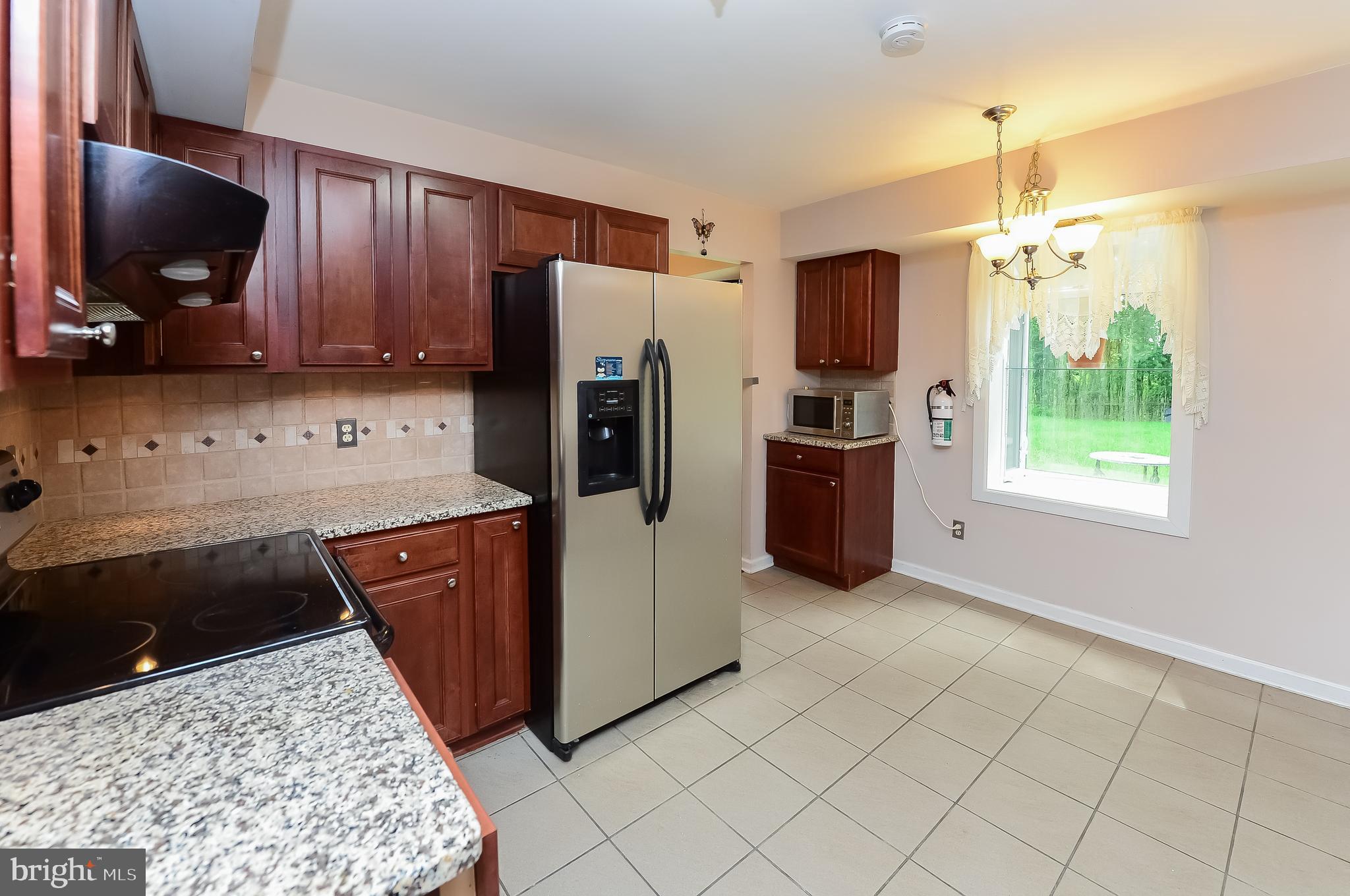 24 Dover Road Westampton, NJ 08060 - Photo 12 of 23 a kitchen with stainless steel appliances granite countertop a refrigerator stove top oven a sink and dishwasher