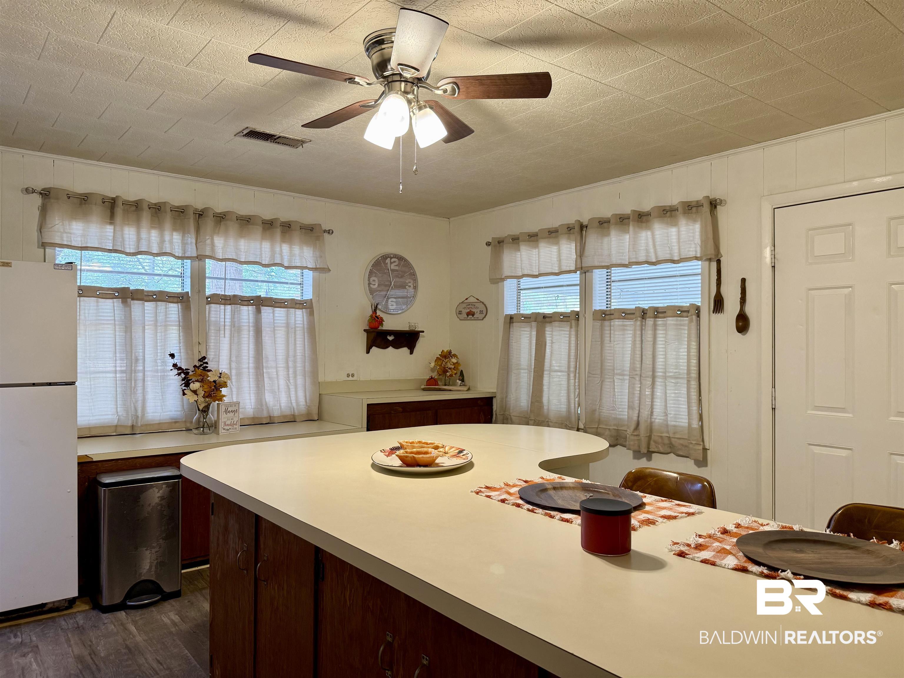 826 West Side Road Castleberry, AL 36432 - Photo 9 of 34 Dining area with ceiling fan and dark wood finished floors
