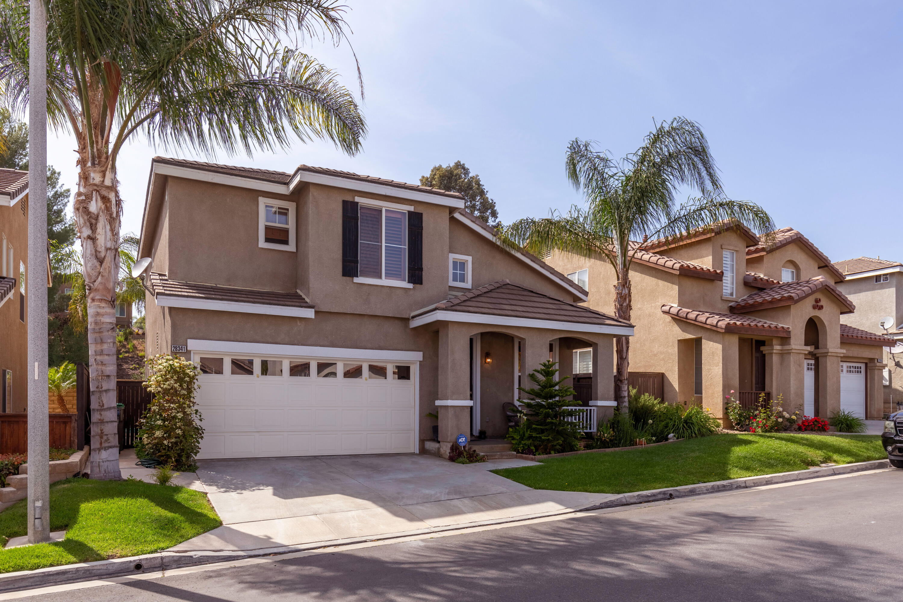 28341 Willow Court Saugus, CA 91350 - Photo 2 of 23 a front view of a house with a yard and garage