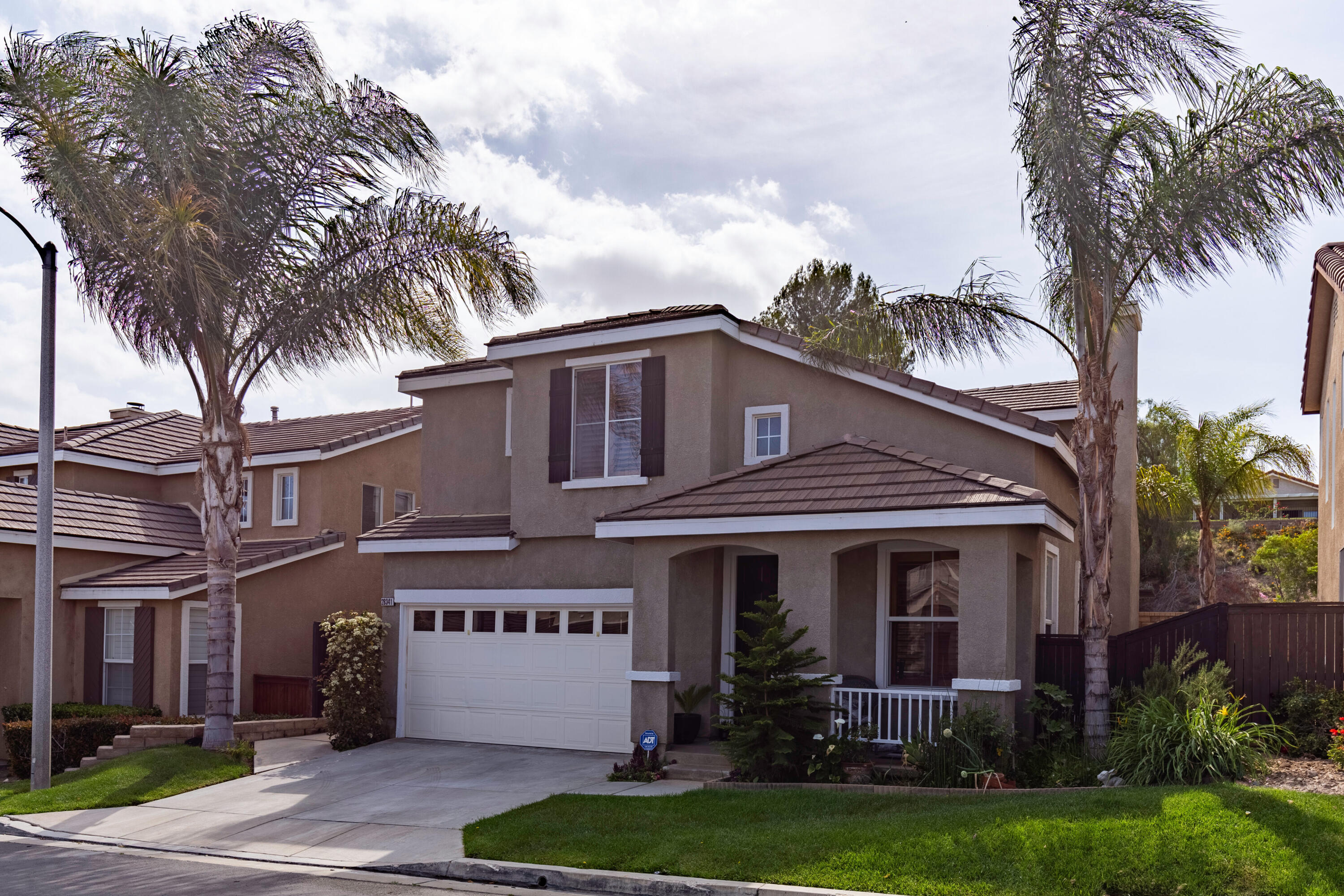 28341 Willow Court Saugus, CA 91350 - Photo 23 of 23 a front view of a house with a garden and palm trees
