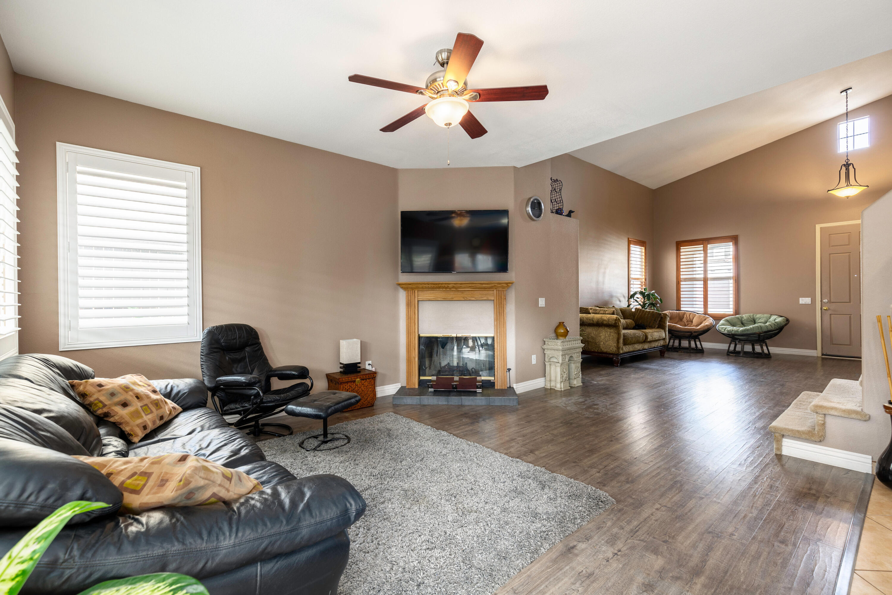 28341 Willow Court Saugus, CA 91350 - Photo 7 of 23 a living room with furniture floor to ceiling window and a flat screen tv