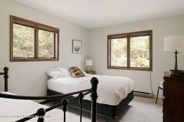 a bathroom with a sink vanity granite shower and a mirror