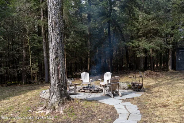 a backyard of a house with table and chairs