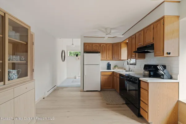 a kitchen with a sink a stove and refrigerator